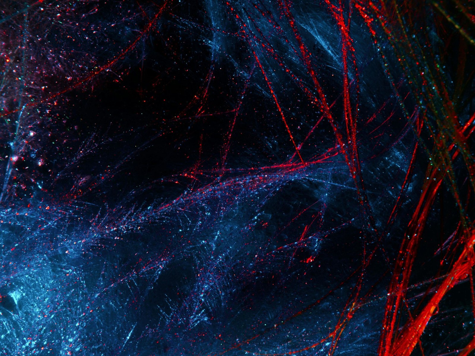 An abstract digital artwork featuring vivid red and blue textures creating a cosmic effect.